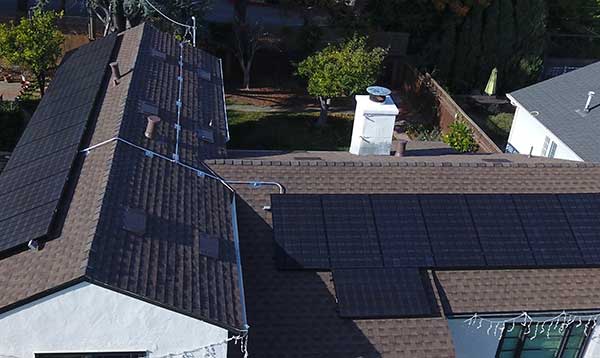 A view of some solar panels on the roof of a house.