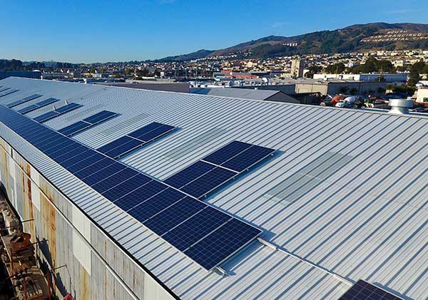 A large building with many solar panels on the roof.