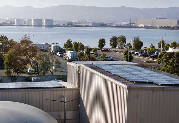 A view of the water from above shows a large building with a solar panel on top.