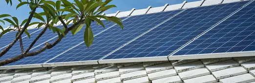 A close up of the solar panels on top of a roof.